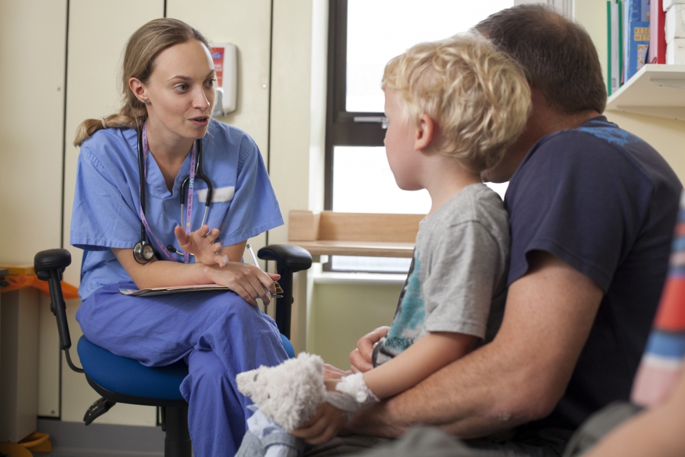 Doctor speaking with child and parent